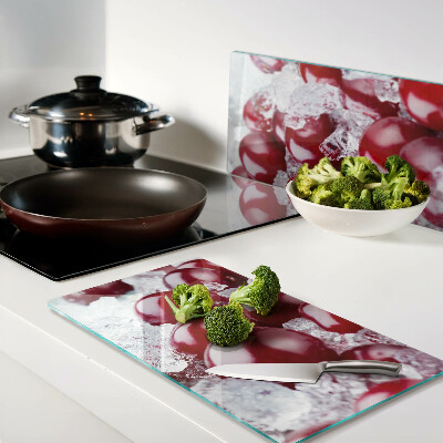 Glass chopping board Red grapes on ice
