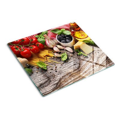 Glass chopping board Italian cuisine with pasta and vegetables