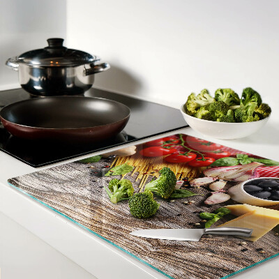Glass chopping board Italian cuisine with pasta and vegetables