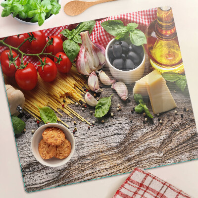 Glass chopping board Italian cuisine with pasta and vegetables