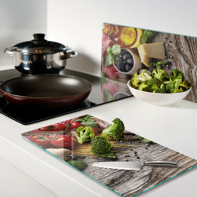 Glass chopping board Italian cuisine with pasta and vegetables