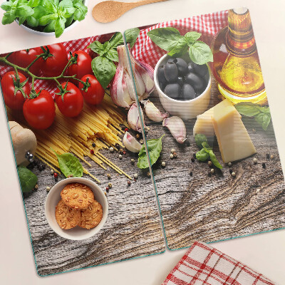 Glass chopping board Italian cuisine with pasta and vegetables