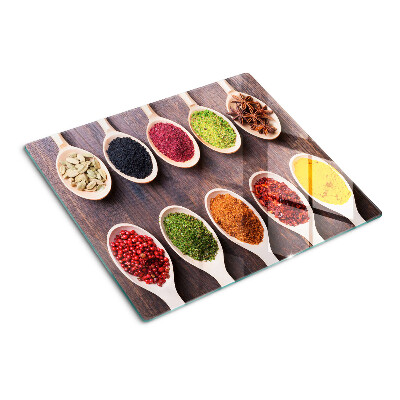 Glass kitchen board Spices in spoons