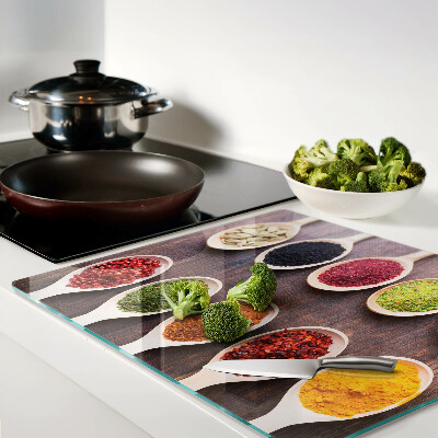 Glass kitchen board Spices in spoons