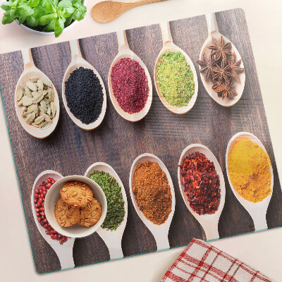 Glass kitchen board Spices in spoons