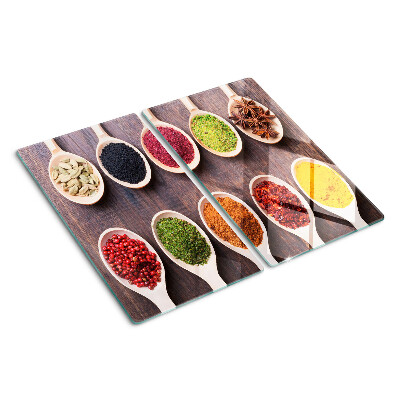 Glass kitchen board Spices in spoons