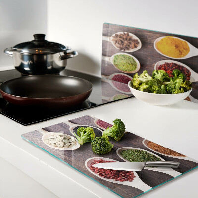 Glass kitchen board Spices in spoons