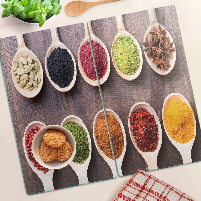 Glass kitchen board Spices in spoons