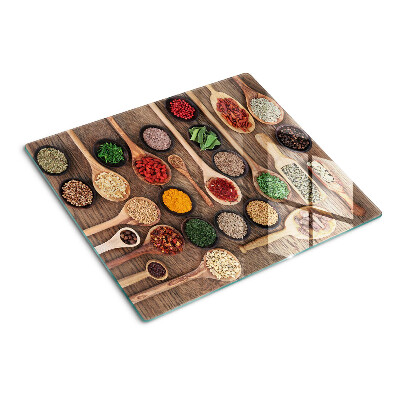 Glass kitchen board Spices and herbs in spoons