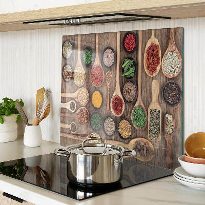 Glass kitchen board Spices and herbs in spoons