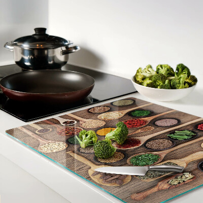 Glass kitchen board Spices and herbs in spoons