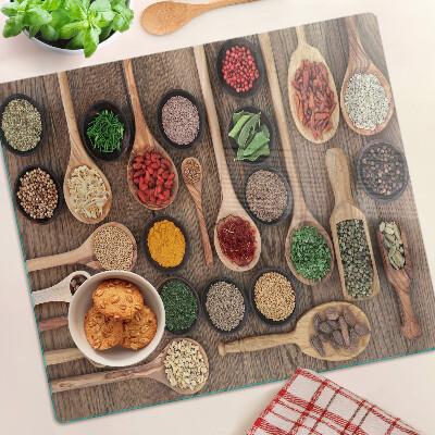 Glass kitchen board Spices and herbs in spoons