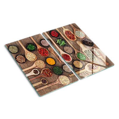 Glass kitchen board Spices and herbs in spoons