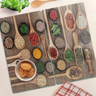 Glass kitchen board Spices and herbs in spoons