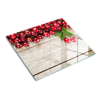Glass kitchen board Cherries on a wooden background