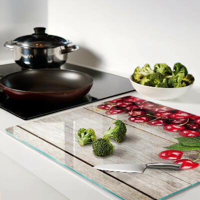 Glass kitchen board Cherries on a wooden background