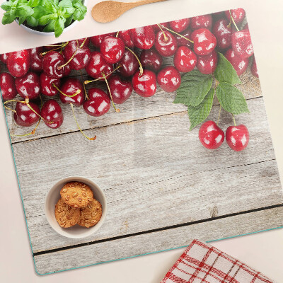 Glass kitchen board Cherries on a wooden background