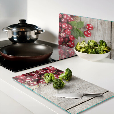 Glass kitchen board Cherries on a wooden background
