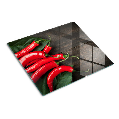 Glass kitchen board Chili peppers on a wooden background