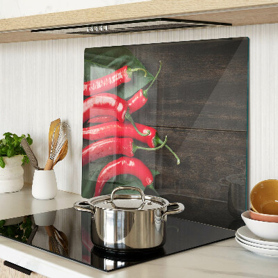 Glass kitchen board Chili peppers on a wooden background