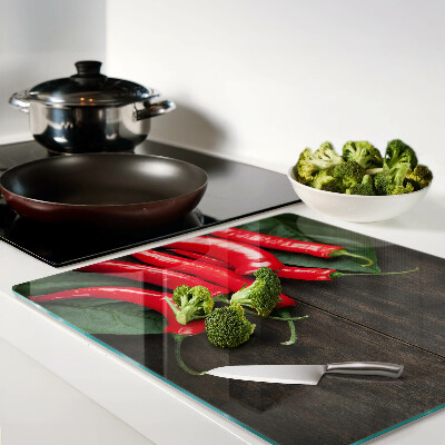 Glass kitchen board Chili peppers on a wooden background