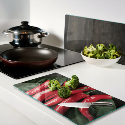 Glass kitchen board Chili peppers on a wooden background