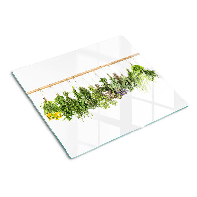 Glass kitchen board Dried herbs on a string