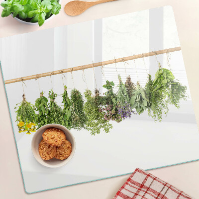 Glass kitchen board Dried herbs on a string