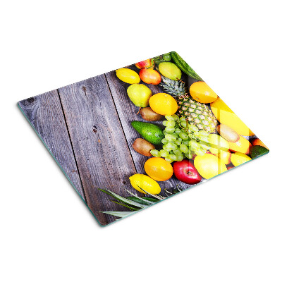 Glass chopping board Fruits on a wooden background