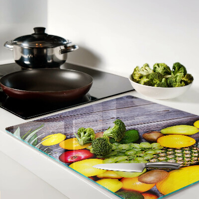 Glass chopping board Fruits on a wooden background