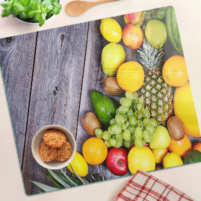 Glass chopping board Fruits on a wooden background