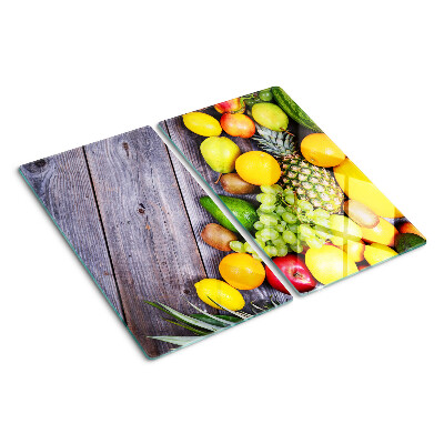 Glass chopping board Fruits on a wooden background