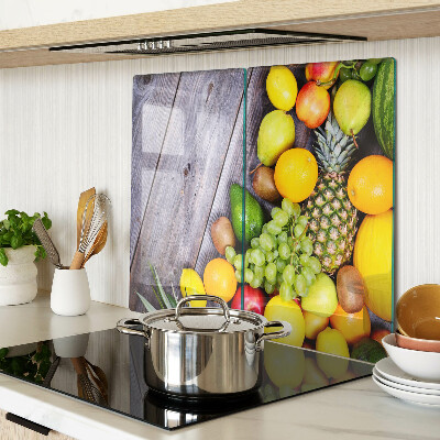 Glass chopping board Fruits on a wooden background