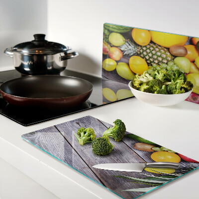 Glass chopping board Fruits on a wooden background