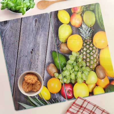 Glass chopping board Fruits on a wooden background