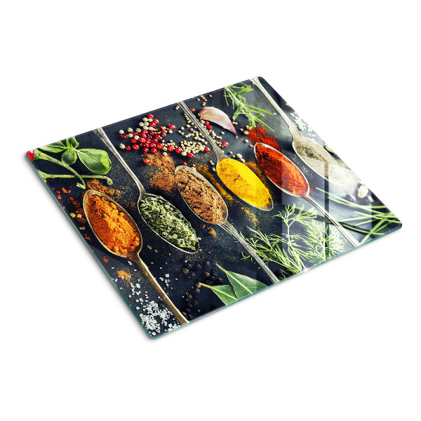Glass kitchen board Spices in spoons