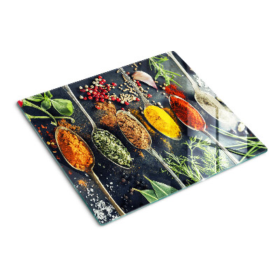 Glass kitchen board Spices in spoons