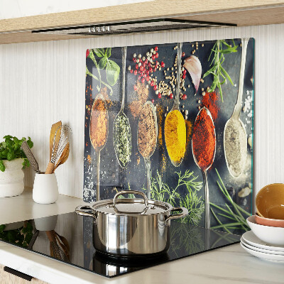 Glass kitchen board Spices in spoons