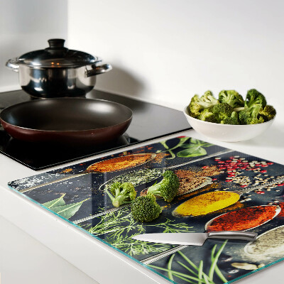 Glass kitchen board Spices in spoons
