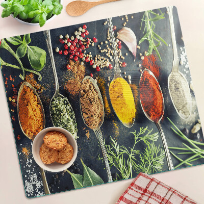 Glass kitchen board Spices in spoons