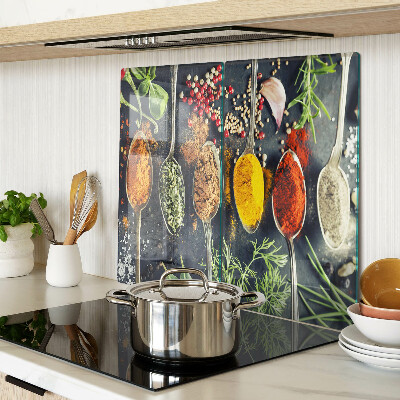 Glass kitchen board Spices in spoons