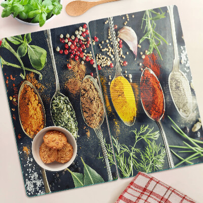 Glass kitchen board Spices in spoons