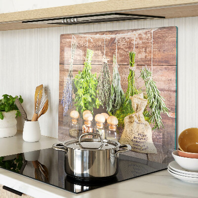 Glass chopping board Herbs and spices on a wood background