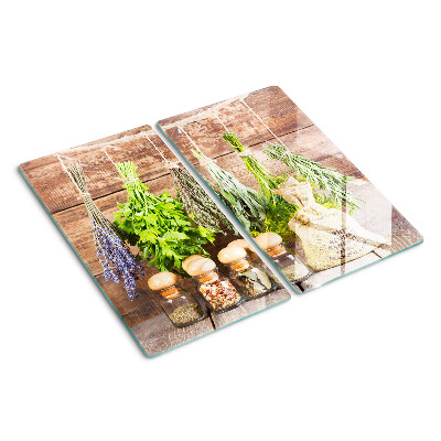 Glass chopping board Herbs and spices on a wood background