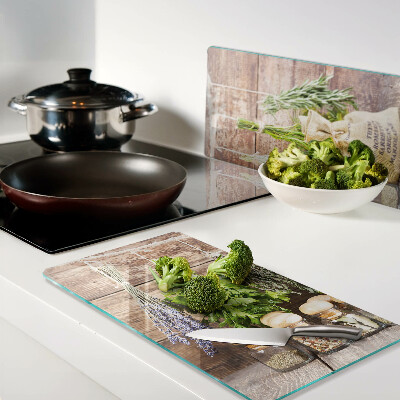 Glass chopping board Herbs and spices on a wood background
