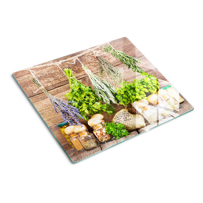 Glass chopping board Herbs and spices in the kitchen