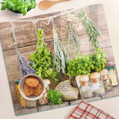 Glass chopping board Herbs and spices in the kitchen
