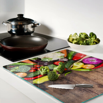 Glass kitchen board Vegetables on a wooden background