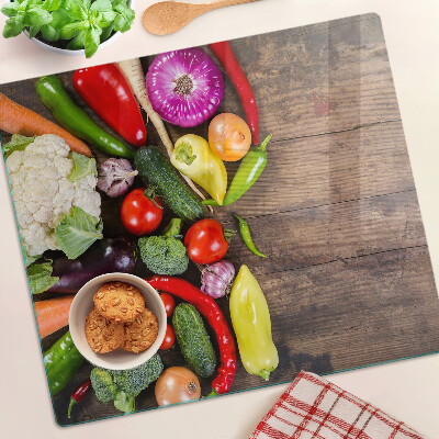 Glass kitchen board Vegetables on a wooden background