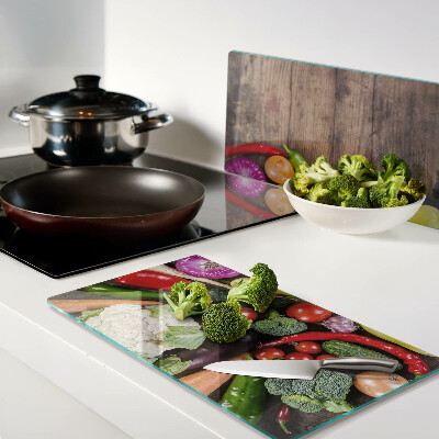 Glass kitchen board Vegetables on a wooden background